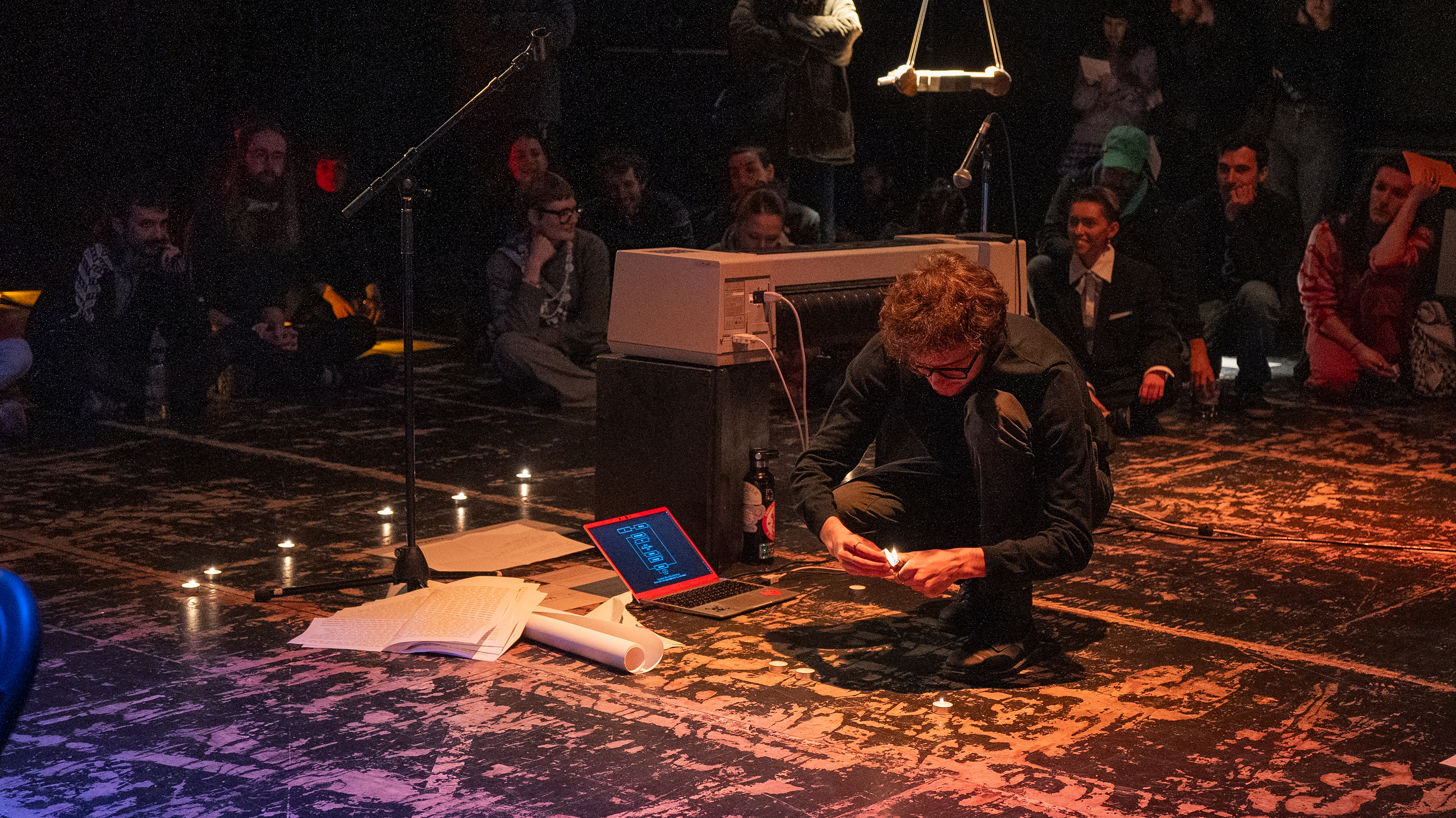 Tommi lighting up candles during the performance “The Metathinking Metamachine”, during the SI28 event at Ubik.