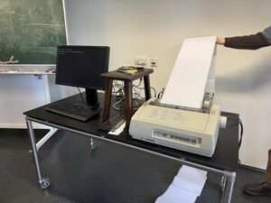 A picture of a printer connected to a Raspberry Pi, connected to a monitor.