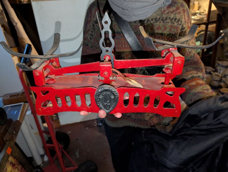 A photo of a antique red scale in Lea’s hands.
