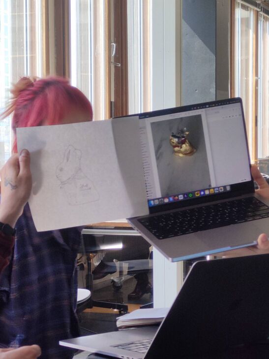 Picture of a drawing and a laptop showcasing an excuisite chocolate bunny (tempested)
